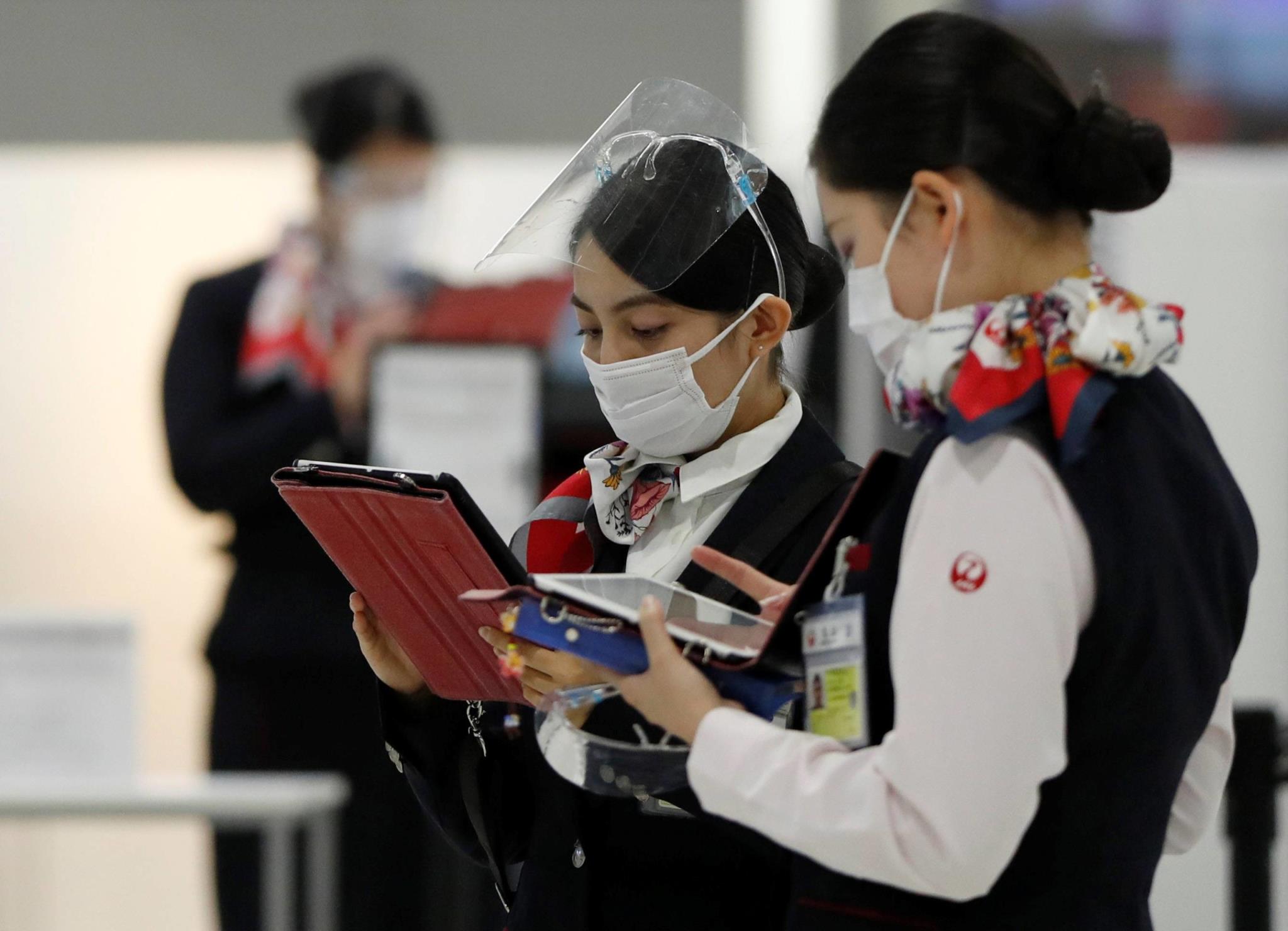 Japan Airlines employees at the departure area in Narita Internatio<em></em>nal Airport in Chiba Prefecture | REUTERS